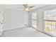 Bedroom with carpet, two windows with blinds and ceiling fan at 125 Sandridge Ct, Alpharetta, GA 30022