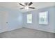 Bedroom features carpet floors, light blue walls, double windows, and ceiling fan with light at 125 Sandridge Ct, Alpharetta, GA 30022