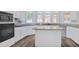Open kitchen with granite countertops, island and stainless appliances at 125 Sandridge Ct, Alpharetta, GA 30022