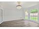 Open living room with chandelier, wood floors and natural light at 125 Sandridge Ct, Alpharetta, GA 30022