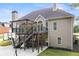 Multi-level deck with pergola, hot tub, and backyard access offers outdoor entertaining space at 150 Rose Creek Dr, Covington, GA 30014