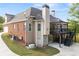 A multi-level deck with outdoor seating is adjacent to a brick and vinyl sided house and attached garage at 150 Rose Creek Dr, Covington, GA 30014