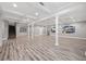 Large finished basement with columns, recessed lighting, and wood-look flooring at 150 Rose Creek Dr, Covington, GA 30014