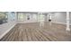 Large finished basement with columns, recessed lighting, and wood-look flooring at 150 Rose Creek Dr, Covington, GA 30014