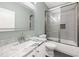 A white bathroom with a sink with granite countertop and shower at 150 Rose Creek Dr, Covington, GA 30014