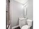 Modern bathroom featuring a vanity, mirror, and shower with tile surround at 150 Rose Creek Dr, Covington, GA 30014