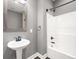 Bathroom featuring a pedestal sink and shower with gray walls at 150 Rose Creek Dr, Covington, GA 30014