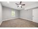 Bedroom with a ceiling fan, natural light, and a carpeted floor at 150 Rose Creek Dr, Covington, GA 30014