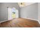 Bedroom featuring high ceilings, a large window with curtains, and beautiful hardwood floors at 150 Rose Creek Dr, Covington, GA 30014