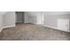 Large bonus room features neutral walls, carpet, and plenty of space for activities at 150 Rose Creek Dr, Covington, GA 30014