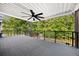A large, covered deck area features a ceiling fan to circulate air, creating a perfect space to unwind at 150 Rose Creek Dr, Covington, GA 30014