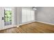 Dining room with hardwood floors, a modern light fixture, and access to a porch at 150 Rose Creek Dr, Covington, GA 30014