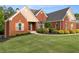 Beautiful brick home with a well manicured lawn and landscaping at 150 Rose Creek Dr, Covington, GA 30014