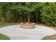 A backyard fire pit surrounded by a paved area provides a cozy outdoor gathering spot at 150 Rose Creek Dr, Covington, GA 30014