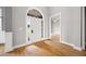 Inviting foyer with light gray walls, white trim, and glossy hardwood floors, leading to other rooms at 150 Rose Creek Dr, Covington, GA 30014