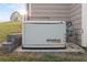 Whole house generator set on a concrete slab with brick surround at 150 Rose Creek Dr, Covington, GA 30014