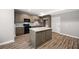 Bright kitchen with an island, stainless steel appliances, ample cabinet space, and sleek countertops at 150 Rose Creek Dr, Covington, GA 30014