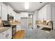 Bright kitchen features granite countertops, stainless steel appliances, and white cabinets with black hardware at 150 Rose Creek Dr, Covington, GA 30014