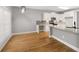 Kitchen and breakfast nook featuring white cabinets, gray walls, and hardwood floors at 150 Rose Creek Dr, Covington, GA 30014