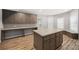 Open kitchen with an island, built-in desk and shelving, great cabinet space, and sleek countertop at 150 Rose Creek Dr, Covington, GA 30014