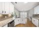 Bright kitchen features granite countertops, stainless steel appliances, white cabinets and an eat-in dining area at 150 Rose Creek Dr, Covington, GA 30014