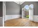 Bright living room features an oversized arched window, hardwood floors and white chair rail at 150 Rose Creek Dr, Covington, GA 30014
