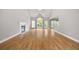 Open-concept space boasts a fireplace, vaulted ceilings, hardwood floors, and access to the outdoors at 150 Rose Creek Dr, Covington, GA 30014
