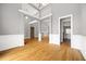 Open concept living room features hardwood floors, gray paint and white trim at 150 Rose Creek Dr, Covington, GA 30014