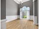 Bright living room features an oversized arched window, hardwood floors and white chair rail at 150 Rose Creek Dr, Covington, GA 30014