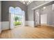 Bright living room features an oversized arched window, hardwood floors and white chair rail at 150 Rose Creek Dr, Covington, GA 30014