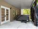 Patio area with a hot tub situated under a deck, providing an ideal space for relaxation at 150 Rose Creek Dr, Covington, GA 30014