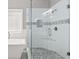 Modern tiled shower with glass doors and pebble floor, next to a soaking tub at 150 Rose Creek Dr, Covington, GA 30014