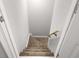 Carpeted staircase with wooden handrail from the upper level looking down at 150 Rose Creek Dr, Covington, GA 30014
