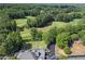 Expansive aerial view showcasing a golf course, clubhouse, playground and lush greenery at 320 Ironhill Trce, Woodstock, GA 30189