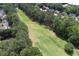 Aerial view overlooking homes next to a pristine golf course, highlighting the lush green landscape and neighborhood layout at 320 Ironhill Trce, Woodstock, GA 30189