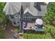 Aerial view of back of house with large deck, outdoor seating, an umbrella and a well-manicured lawn at 320 Ironhill Trce, Woodstock, GA 30189