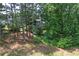 A beautiful home surrounded by towering trees, offering a backyard with a deck and expansive views at 320 Ironhill Trce, Woodstock, GA 30189