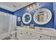 Bright bathroom featuring dual sinks, vanity, and tub with shower at 320 Ironhill Trce, Woodstock, GA 30189
