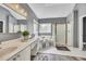 Bright bathroom featuring double vanity, soaking tub, and glass-enclosed shower at 320 Ironhill Trce, Woodstock, GA 30189