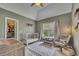 Bedroom featuring a crib, rocking chair, changing table, and ample natural light at 320 Ironhill Trce, Woodstock, GA 30189