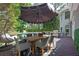 Inviting outdoor deck features dining and lounge seating with overhead shade umbrella at 320 Ironhill Trce, Woodstock, GA 30189