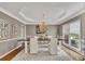Elegant dining room featuring a large wooden table, tray ceiling, and plenty of natural light from the windows at 320 Ironhill Trce, Woodstock, GA 30189