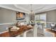 Dining room showcasing a rustic wood table, chandelier lighting, and neutral wall colors for an inviting atmosphere at 320 Ironhill Trce, Woodstock, GA 30189