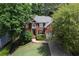 Charming brick home with a well-manicured lawn, mature trees, and a welcoming front entrance at 320 Ironhill Trce, Woodstock, GA 30189