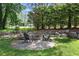 Outdoor fire pit with stone patio and Adirondack chairs, perfect for entertaining at 320 Ironhill Trce, Woodstock, GA 30189