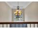 Beautiful foyer chandelier with large window bringing in lots of natural light at 320 Ironhill Trce, Woodstock, GA 30189