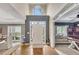 Bright, airy foyer with hardwood floors, a soaring ceiling, and views into the living and dining spaces at 320 Ironhill Trce, Woodstock, GA 30189