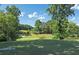 Scenic golf course view surrounded by mature trees and a manicured lawn on a bright sunny day at 320 Ironhill Trce, Woodstock, GA 30189