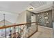 Second-floor hallway with picture frame moulding and iron-wrought railing at 320 Ironhill Trce, Woodstock, GA 30189