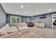 Spacious living room featuring a large sectional sofa, recliner, and television at 320 Ironhill Trce, Woodstock, GA 30189